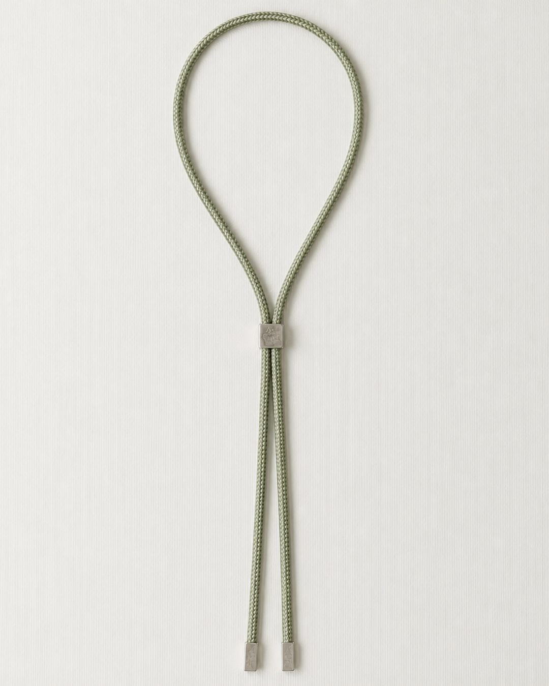 The same in sage green, silver slider and tips, flat on cream