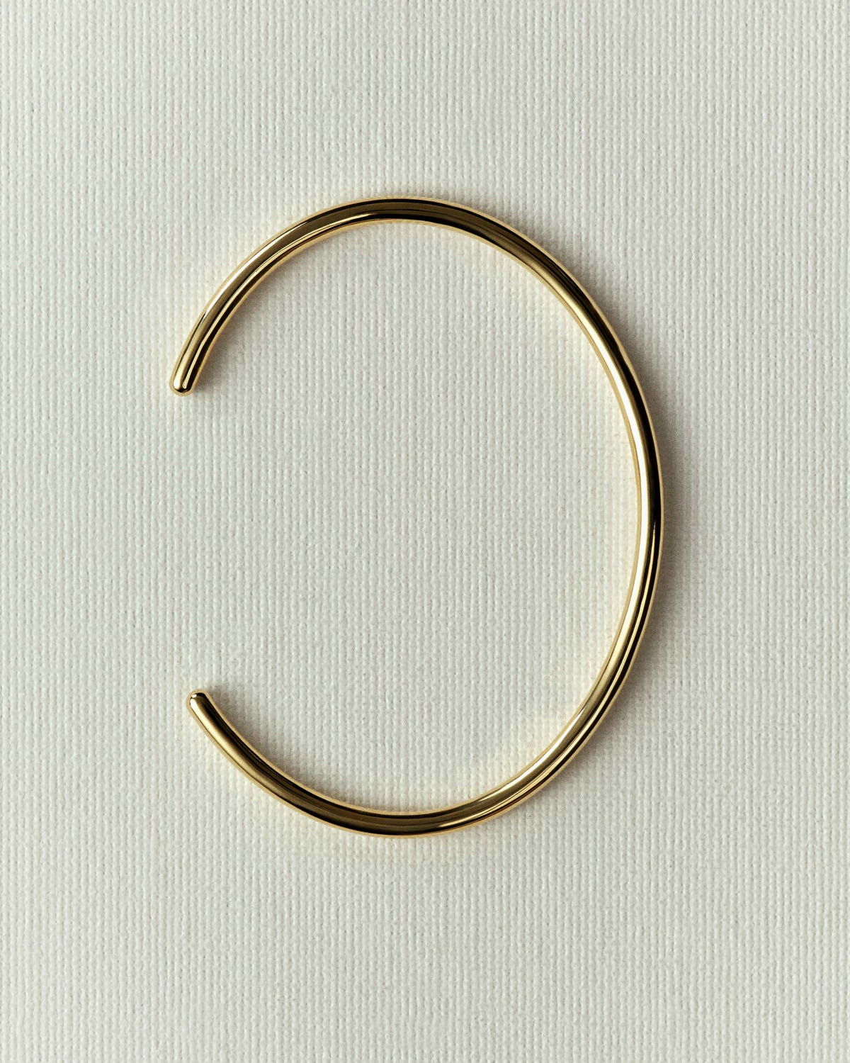 The same cuff in gold, opening turned to the left