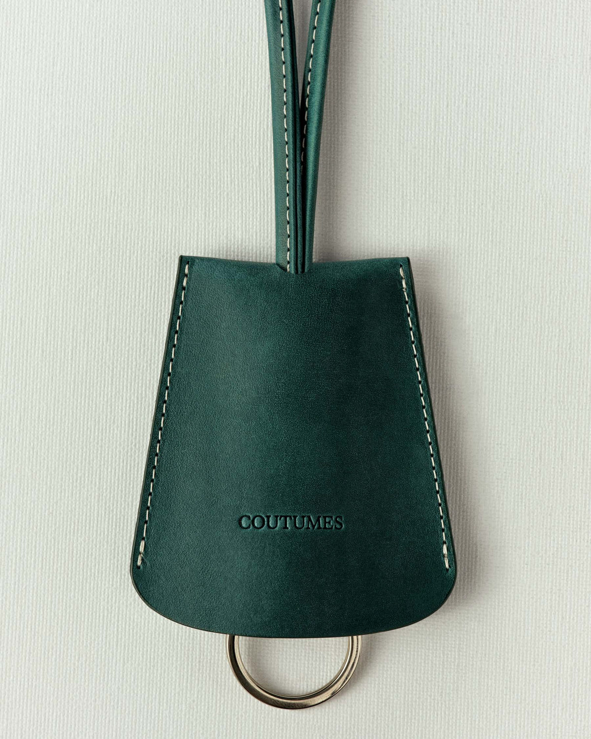 The same in fir green leather, off-white stitching and a long folded strap