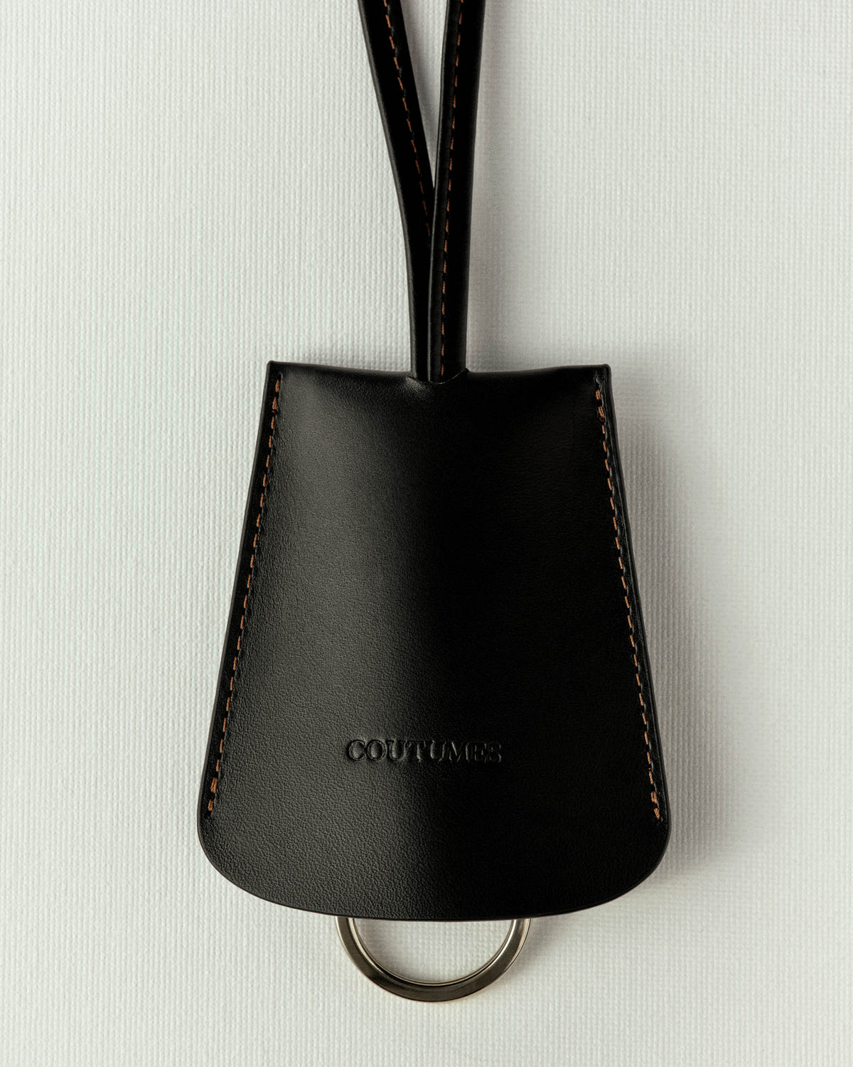 Black leather version, orange stitching, key ring peeking out below the shell