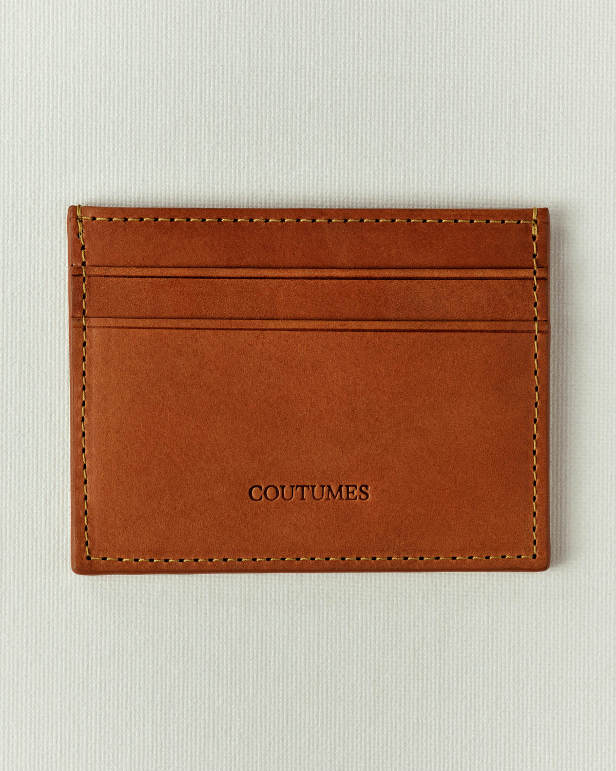 Smooth cognac leather, three card slots and tonal stitching