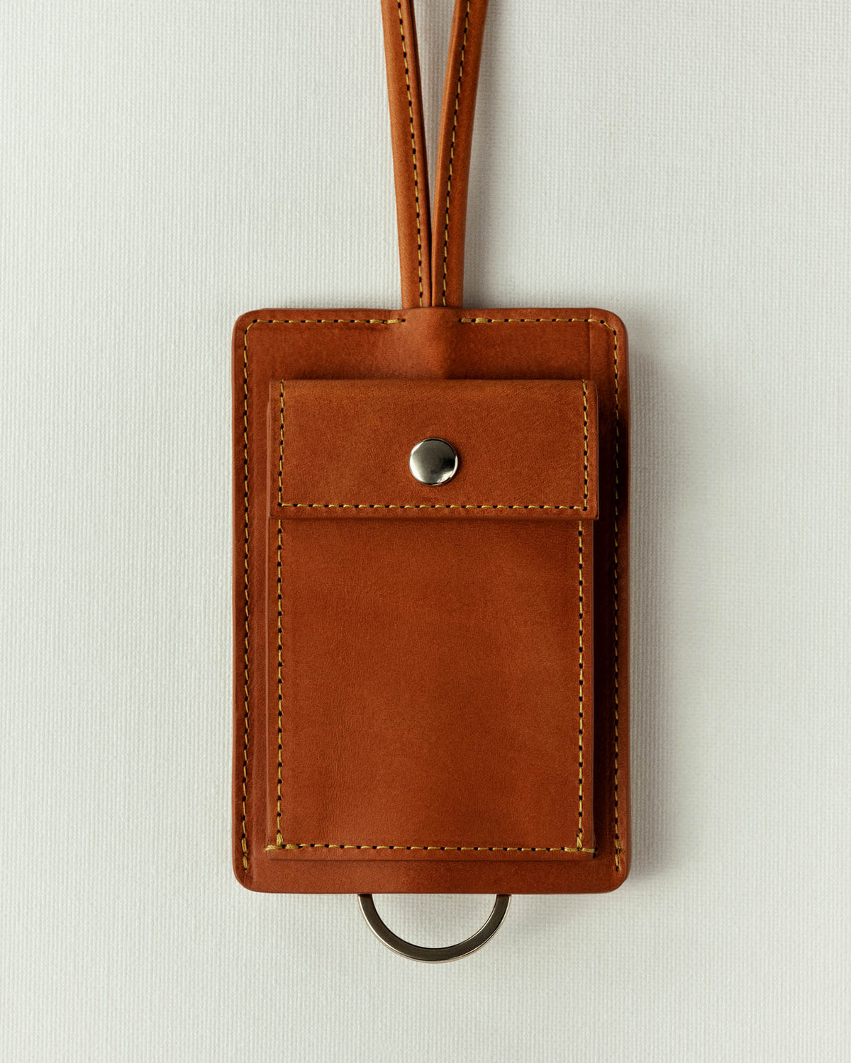 Smooth cognac leather version, yellow stitching, key ring showing below the pocket