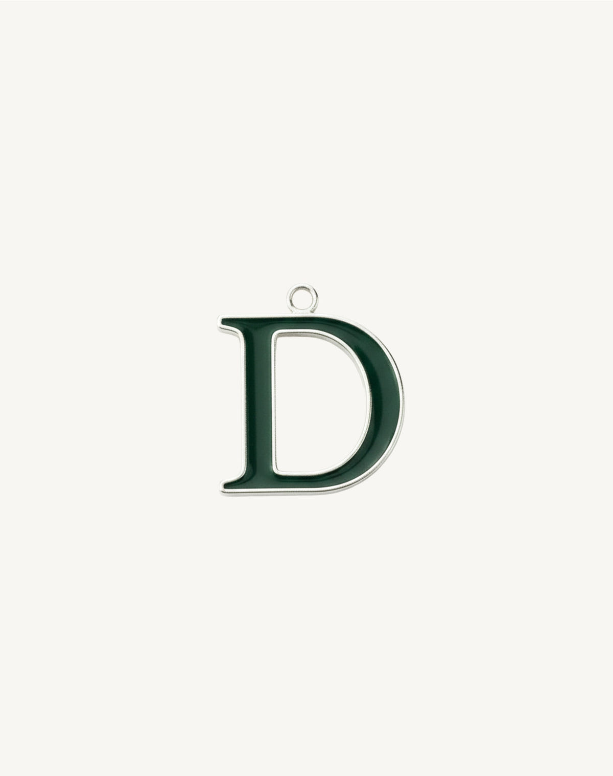 Rounded letter D, dark green enamel edged in silver, cream background