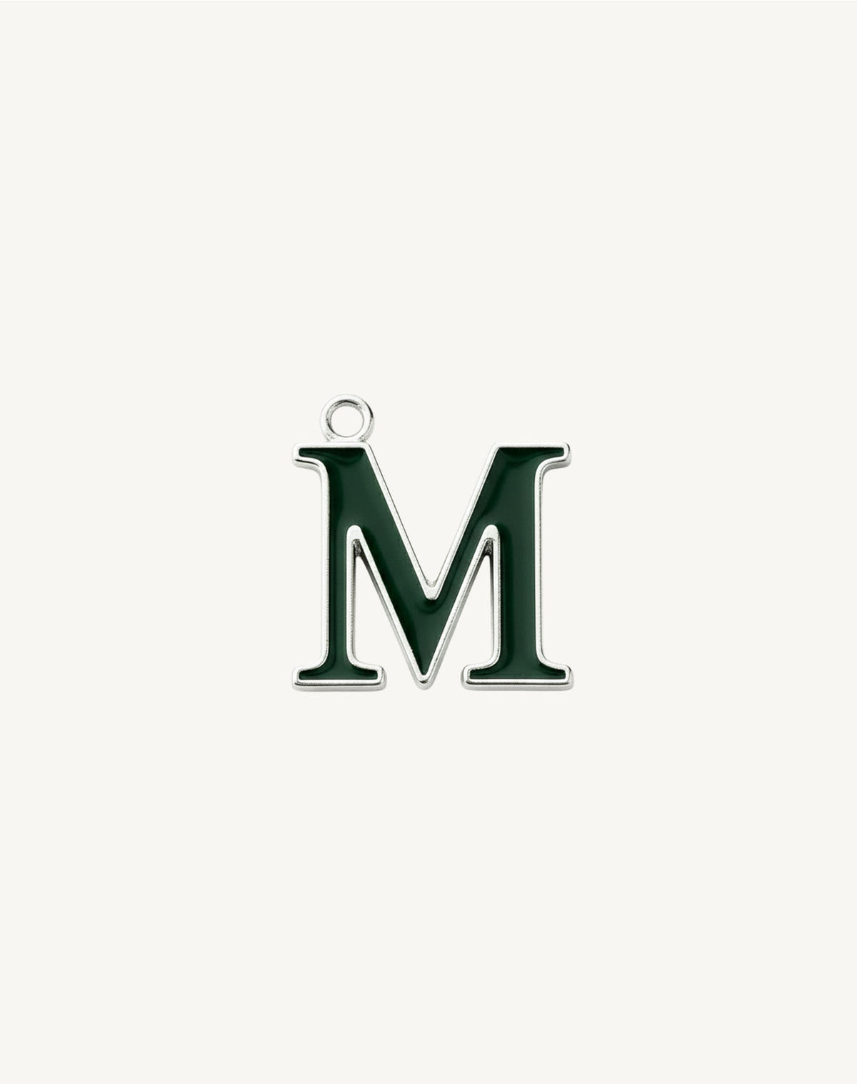Four-stroke letter M, dark green enamel outlined in silver, cream background