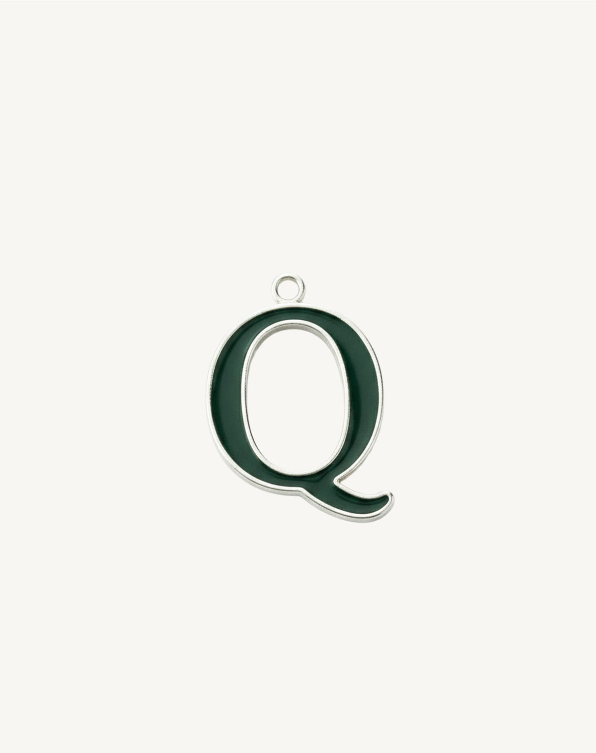 Oval letter Q with a trailing tail, dark green enamel outlined in silver, cream background