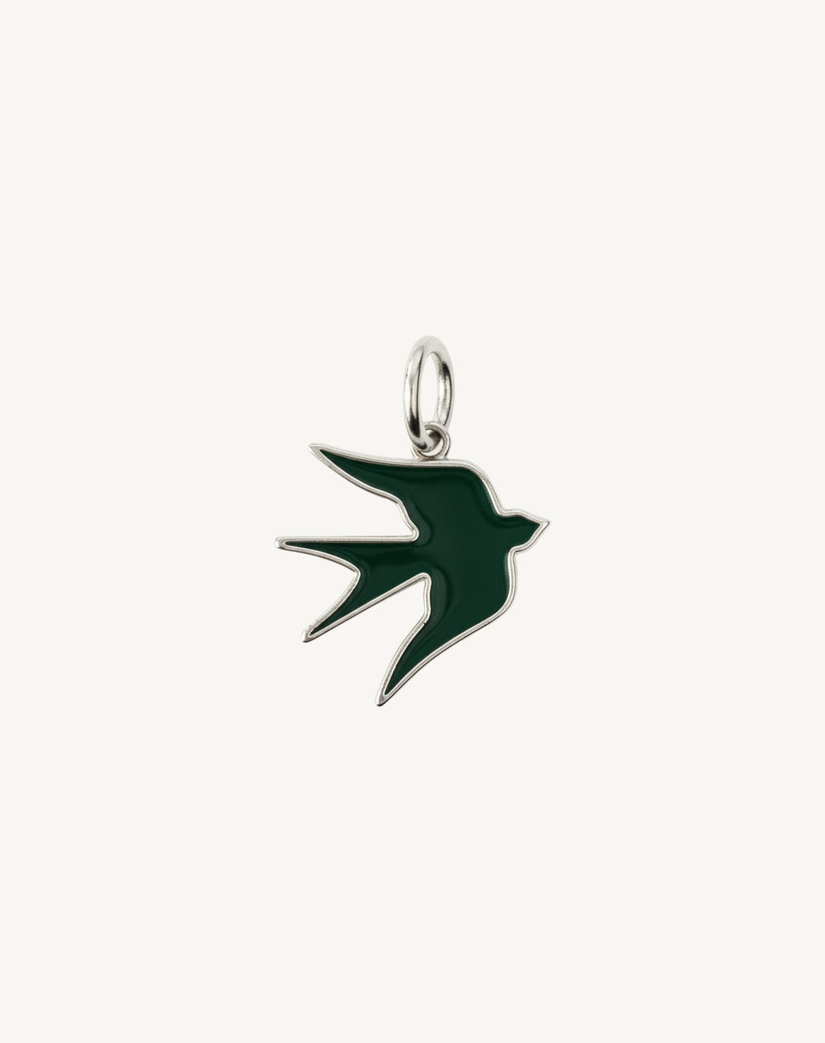 The same green enamelled bird, this time outlined in silver on cream